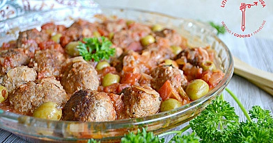Baked Lithuanian pork meatballs with tomatoes and olives