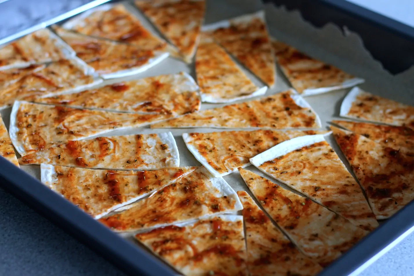 Tortilijų traškučiai su druska, raudonėliu, baziliku ir pomidorų padažu