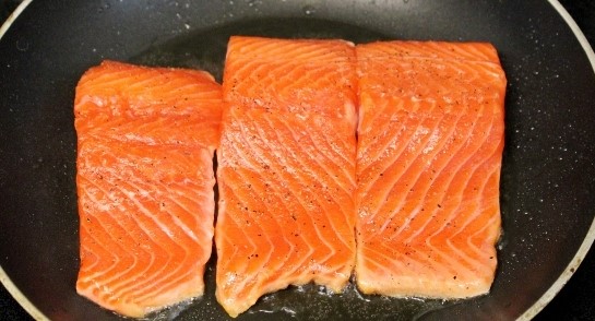 cooking salmon in a pan