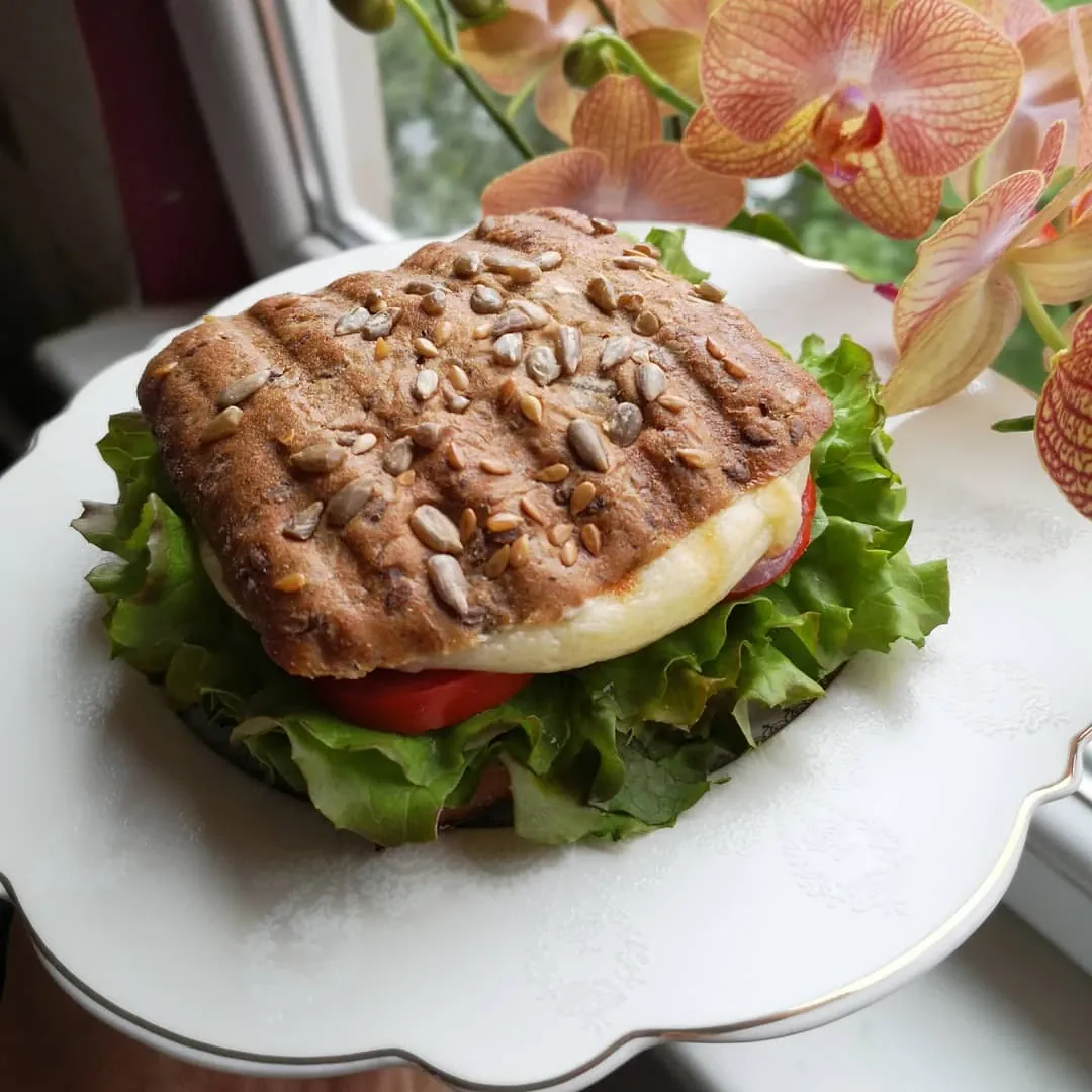 Sveikas ir sotus naminis burgeris su avokadu, kepamu sūriu ir daržovėmis Sveikas ir sotus naminis burgeris su avokadu, kepamu sūriu ir daržovėmis