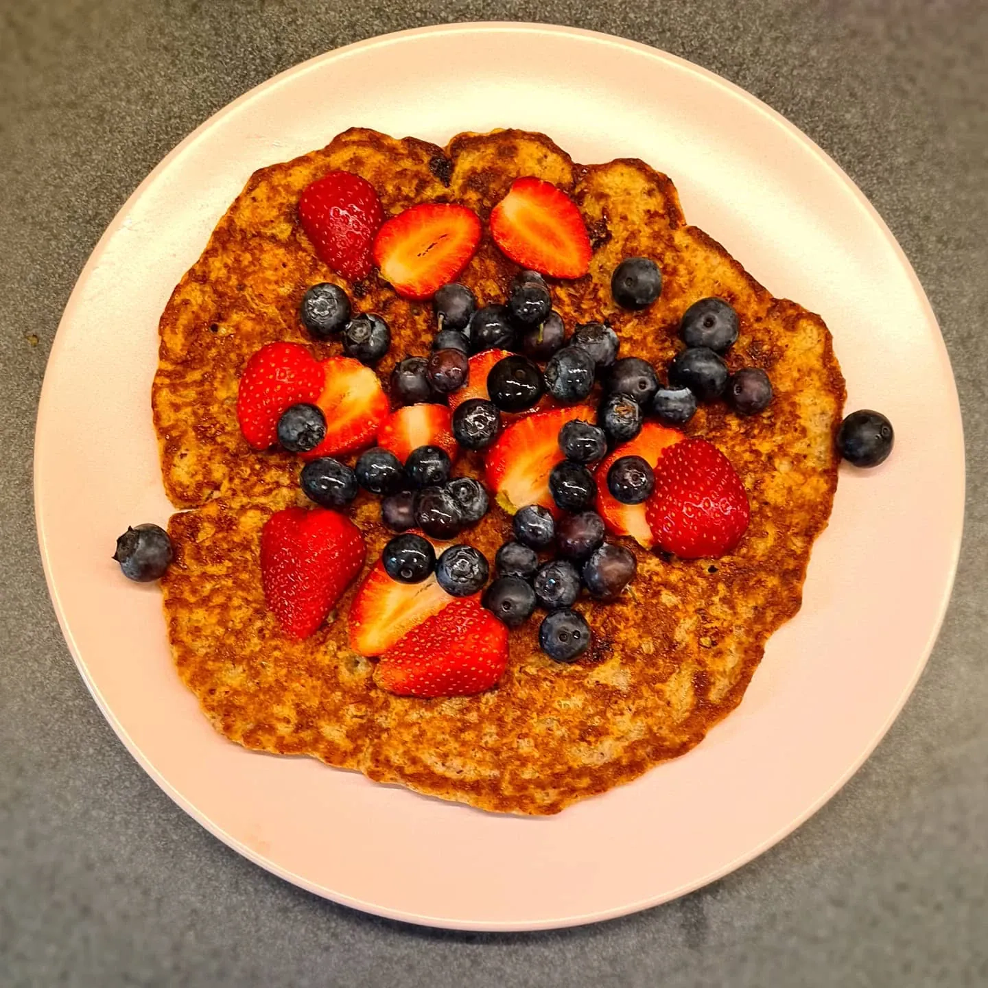 Veselīga auzu pankūka ar banānu, zemenēm un mellenēm