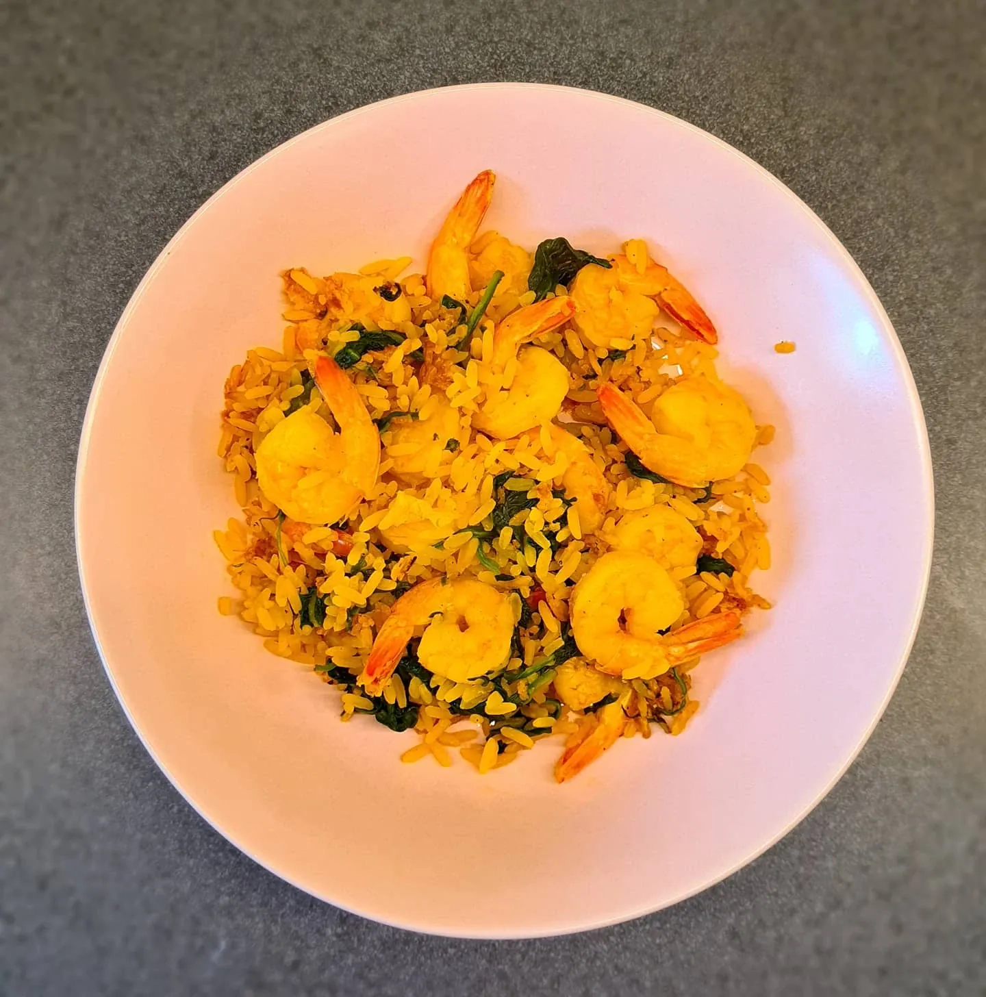 Rīsi ar spinātiem, garnelēm un paeljas garšvielām