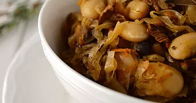 Troškinti rauginti kopūstai, gardinti džiovintais grybais ir pupelėmis