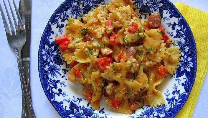 Pasta with smoked sausages and sour cream - tomato sauce